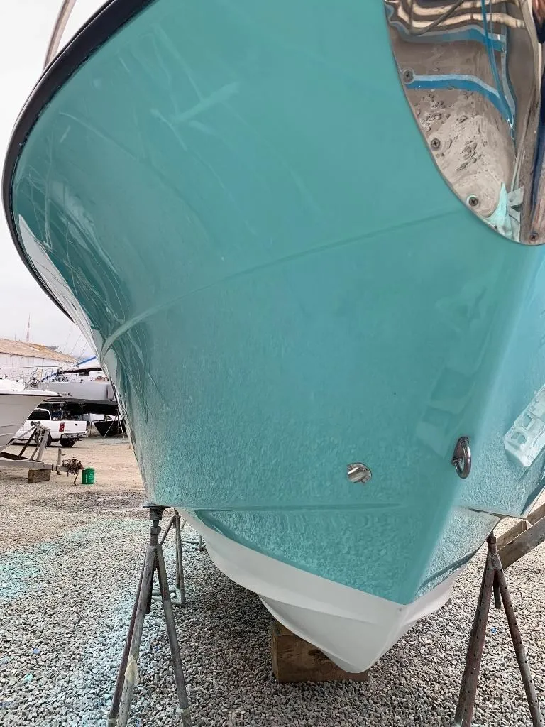 Close-up of gelcoat finish on a bow, turquoise hull