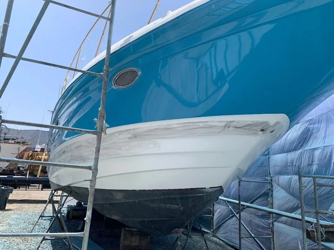 Freshly painted turquoise hull on scaffolding